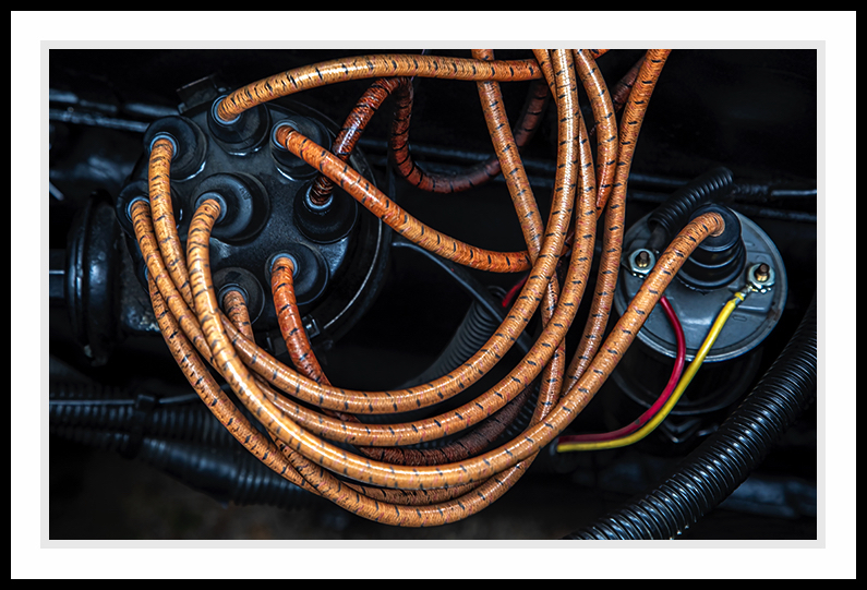 Under the hood with orange wires.